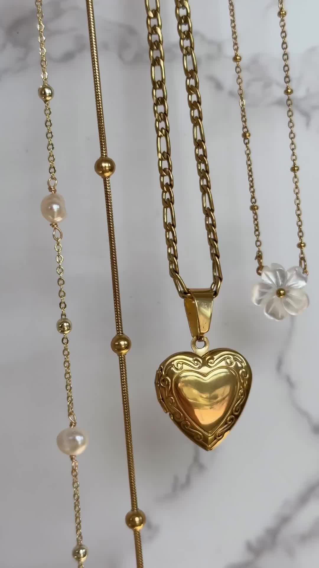 This contains: gold heart locket necklace, gold choker, gold neck stack, gold jewelry, gold jewelry inspo, summer jewelry inspo