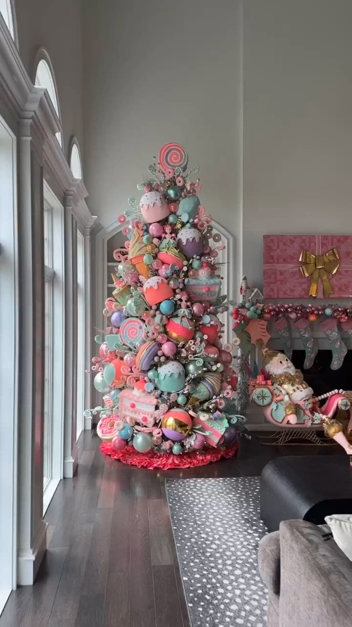 This may contain: a very colorful christmas tree with lots of ornaments on it's top and bottom