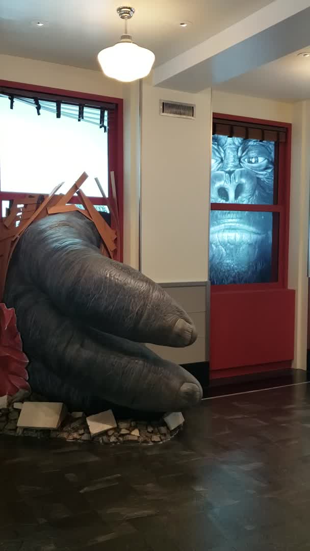 This may contain: an elephant statue sitting in the middle of a room next to a red door and window