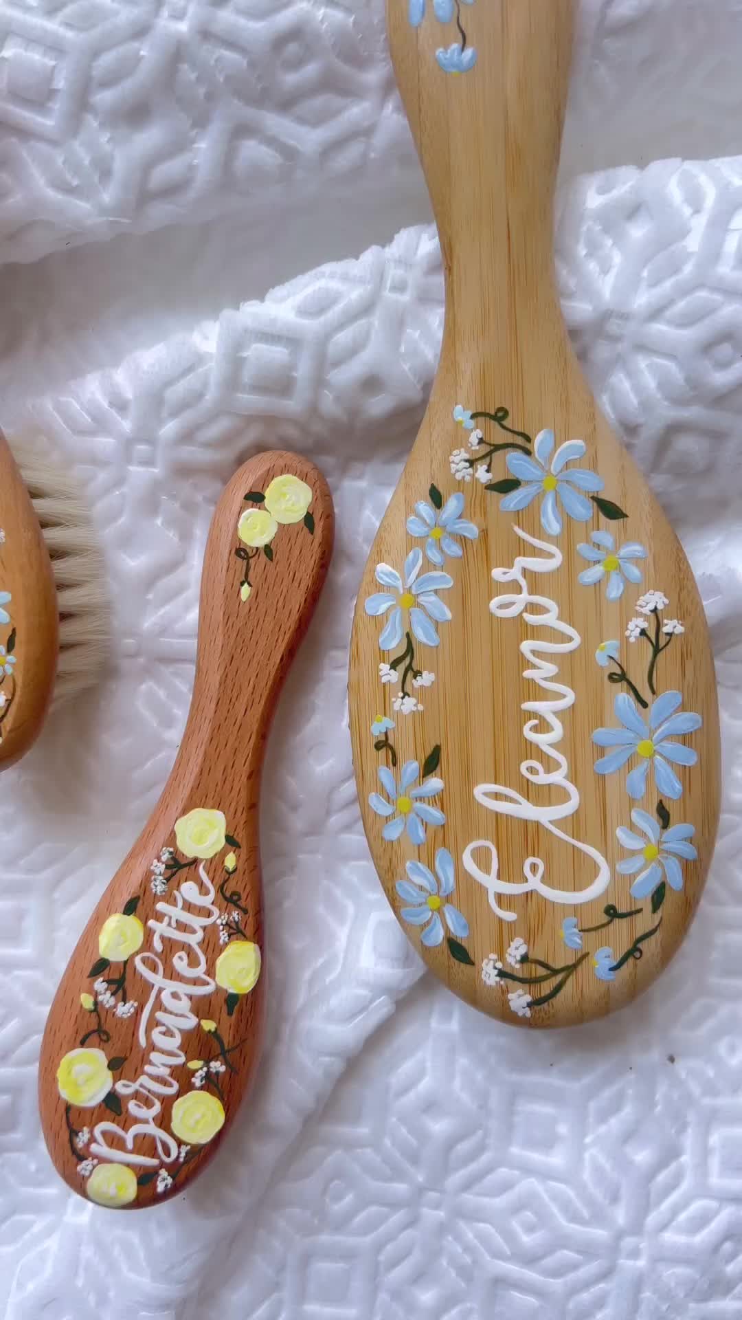 This may contain: three wooden spoons decorated with flowers and words