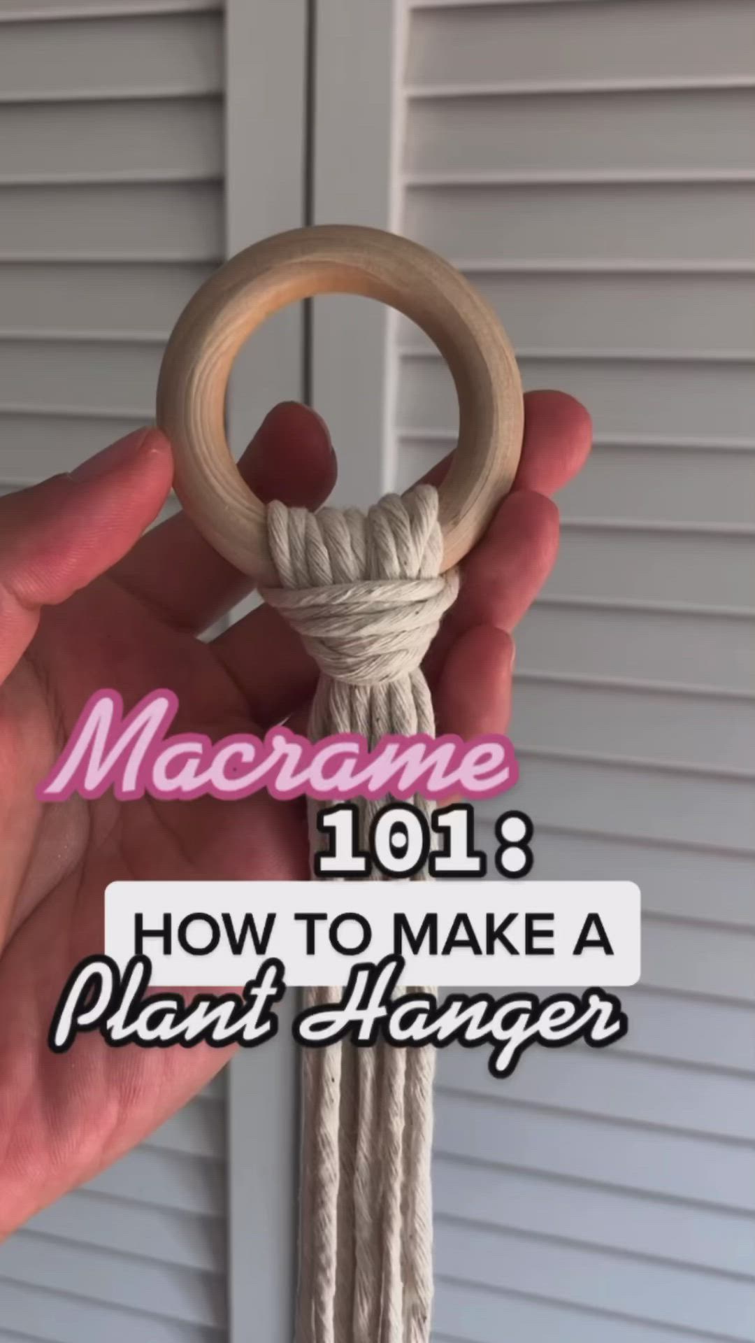 This may contain: someone holding a wooden ring with rope on it and the words macrame 1018 how to make a plant hanger