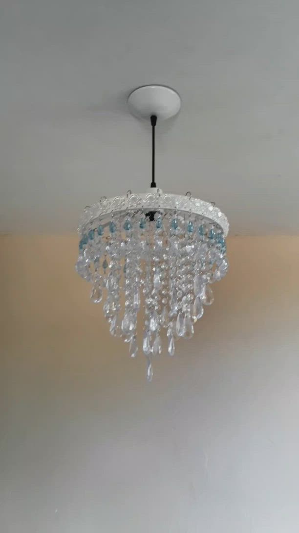 This may contain: a chandelier hanging from the ceiling in a room