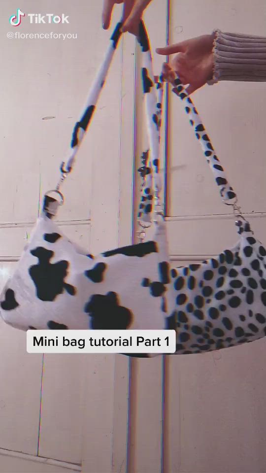 This may contain: someone is holding a purse with a dalmatian print on it and the text, mini bag tutor part 1