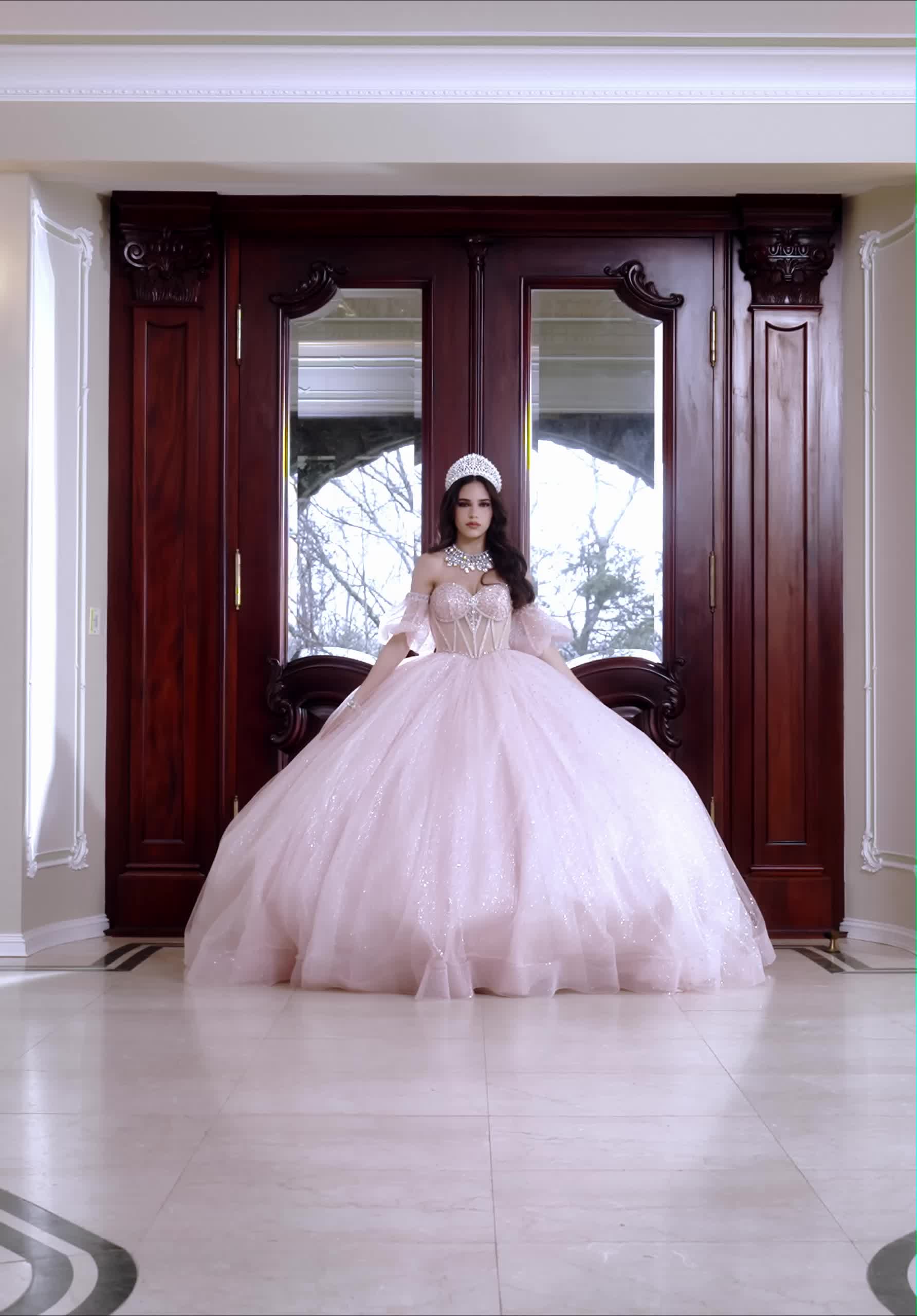 This may contain: a woman in a pink ball gown standing next to a wooden door