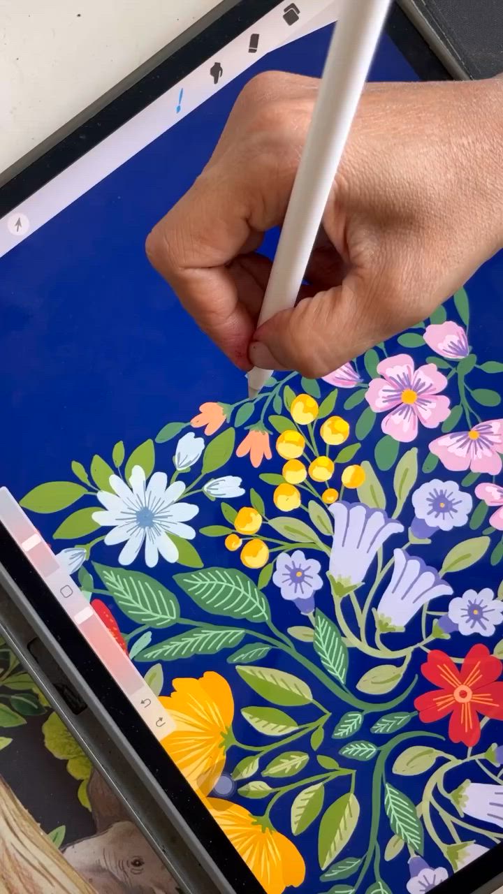 This may contain: a person is using a pencil to draw flowers on a blue background with white writing