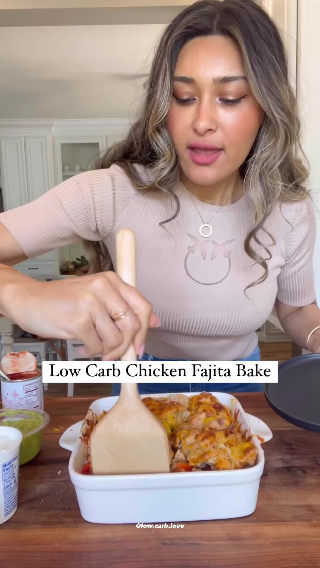 This may contain: a woman making a low carb chicken fajita bake