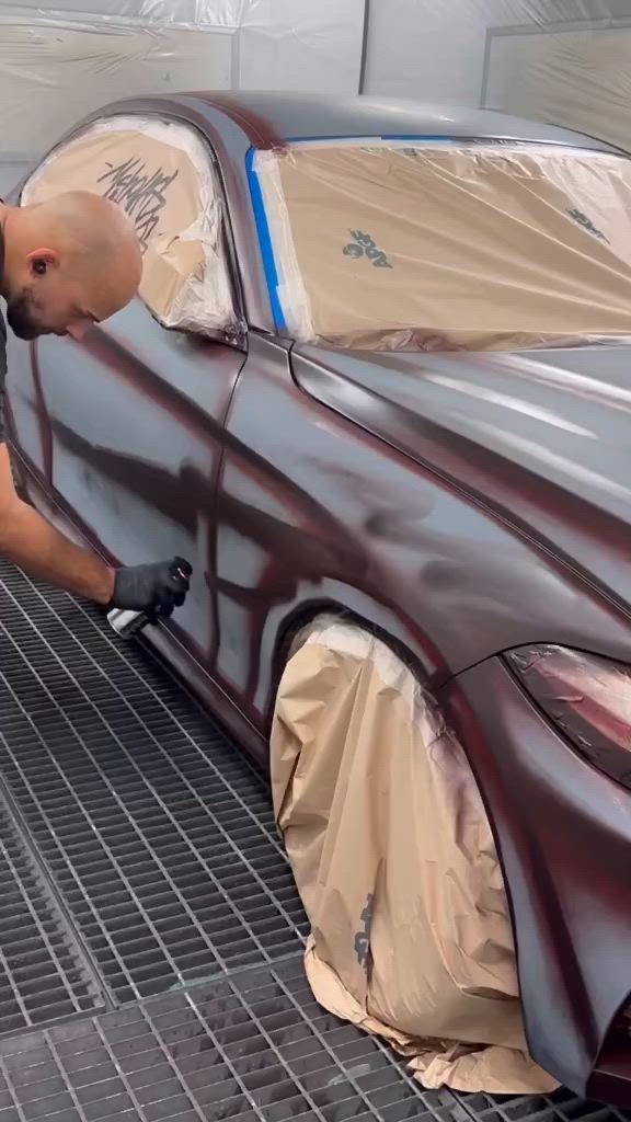 This may contain: a man is painting a car in chocolate