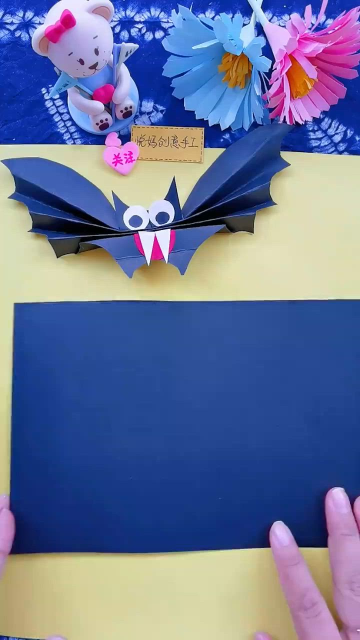 This may contain: two paper bats are sitting on a table