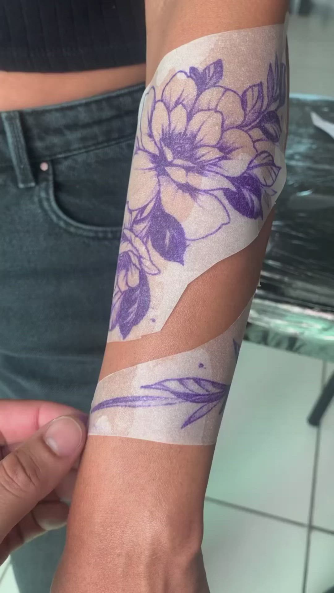 This may contain: a woman's arm with flowers and butterflies on it