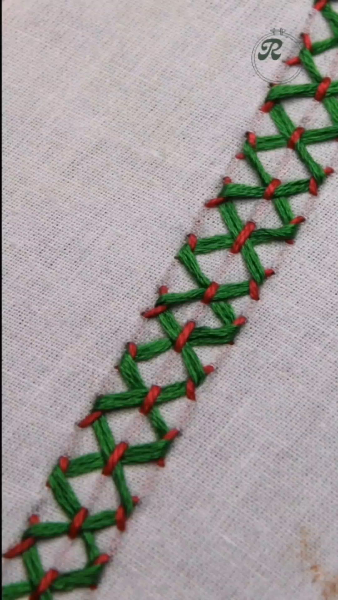 This may contain: a close up of a piece of cloth with green and red stitching on it