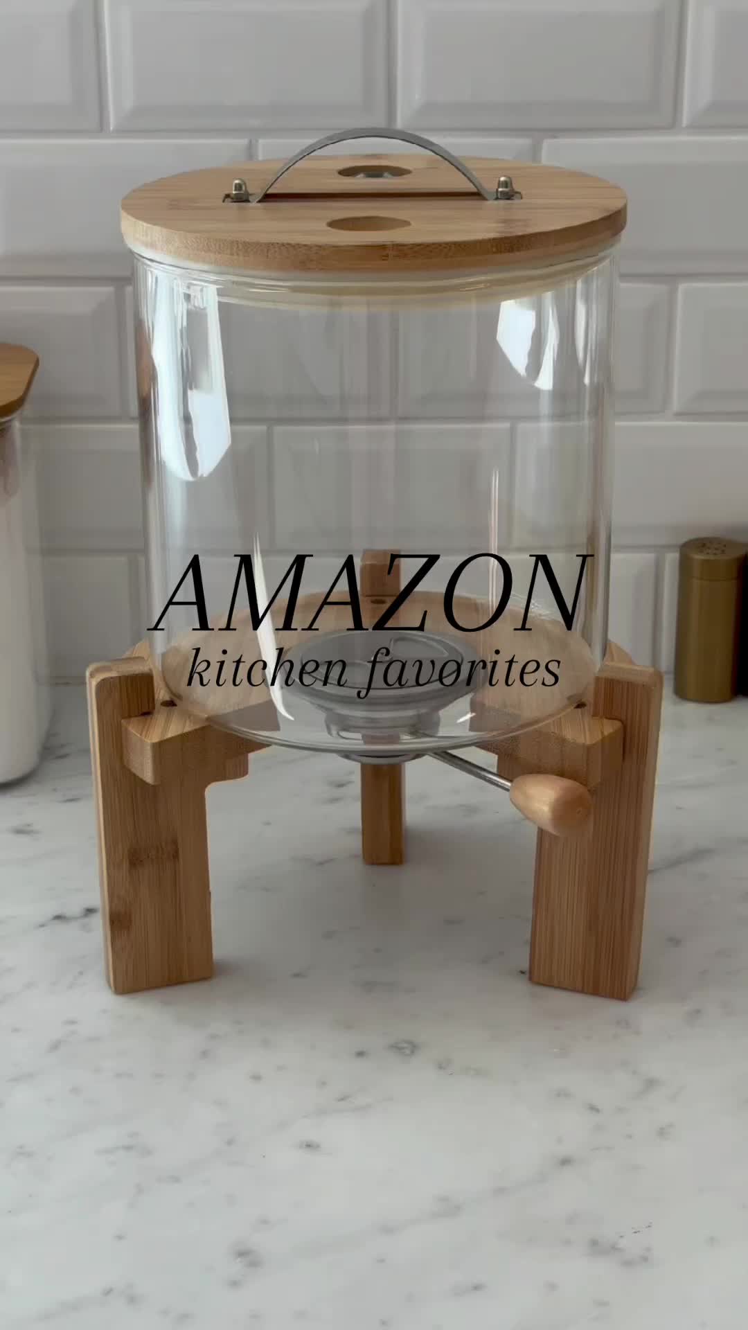 This may contain: a glass container with wooden legs on a counter