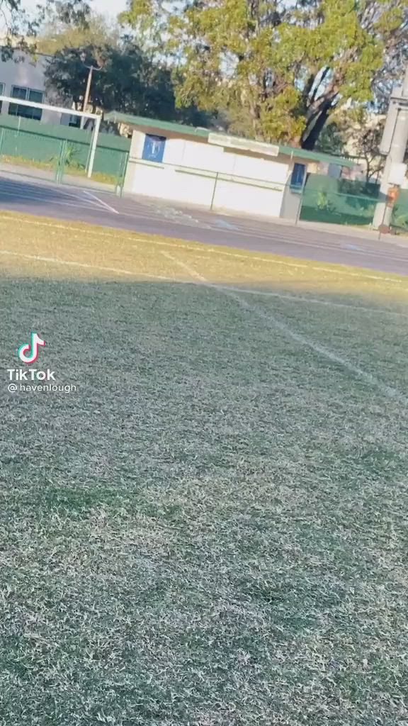 This may contain: a young man standing on top of a soccer field