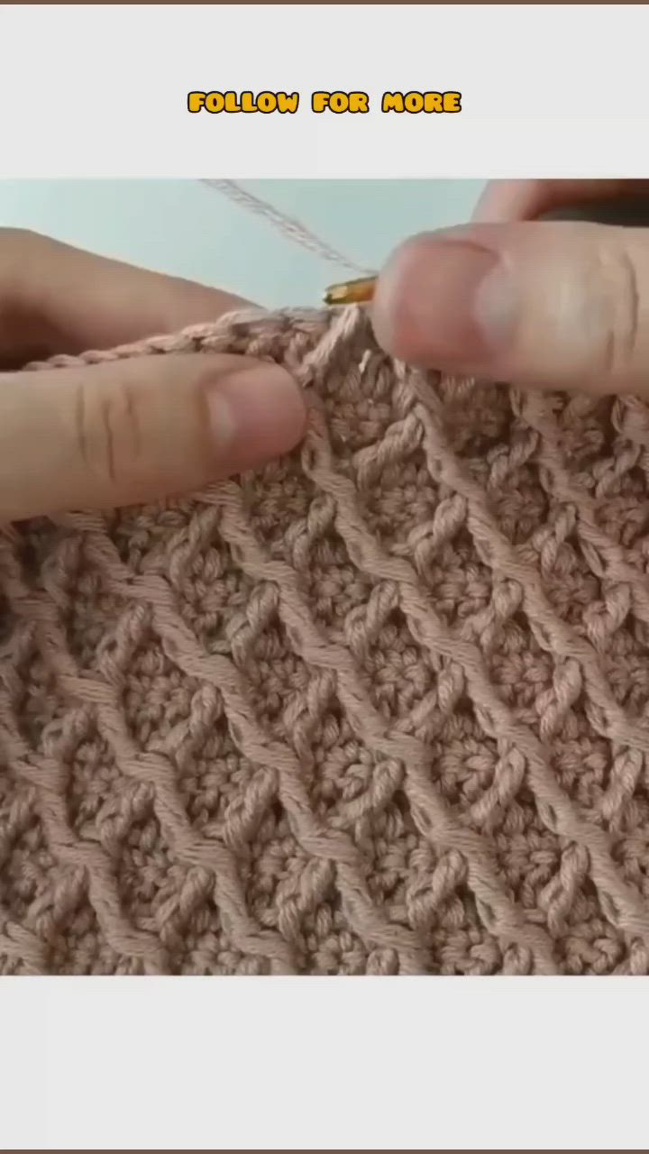 This may contain: someone crocheting the stitchs on a piece of yarn with their hands and fingers