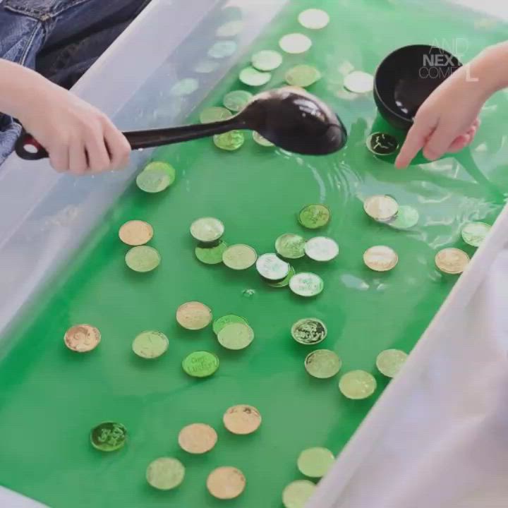 This may contain: two children are making a st patrick's day sensory soup