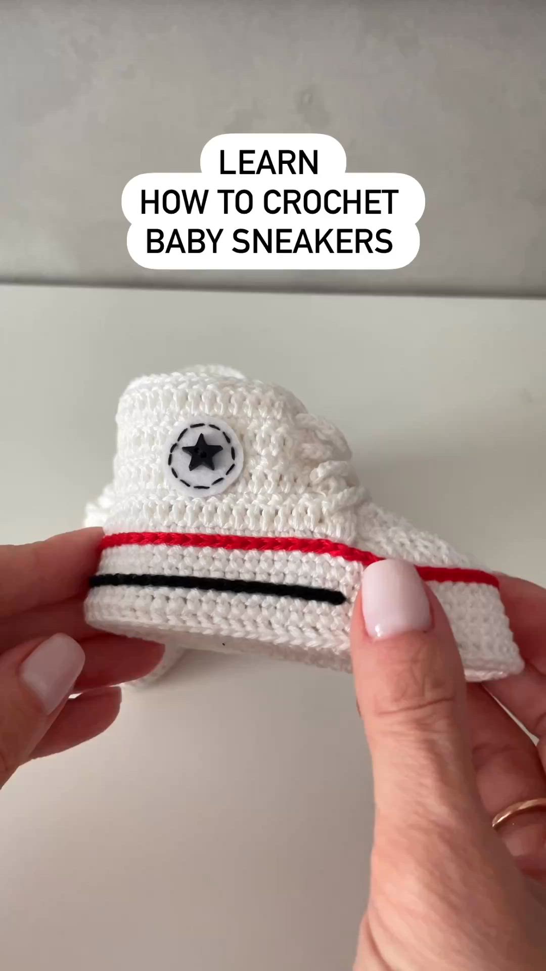 This may contain: someone is crocheting a baby sneaker with the words learn how to crochet