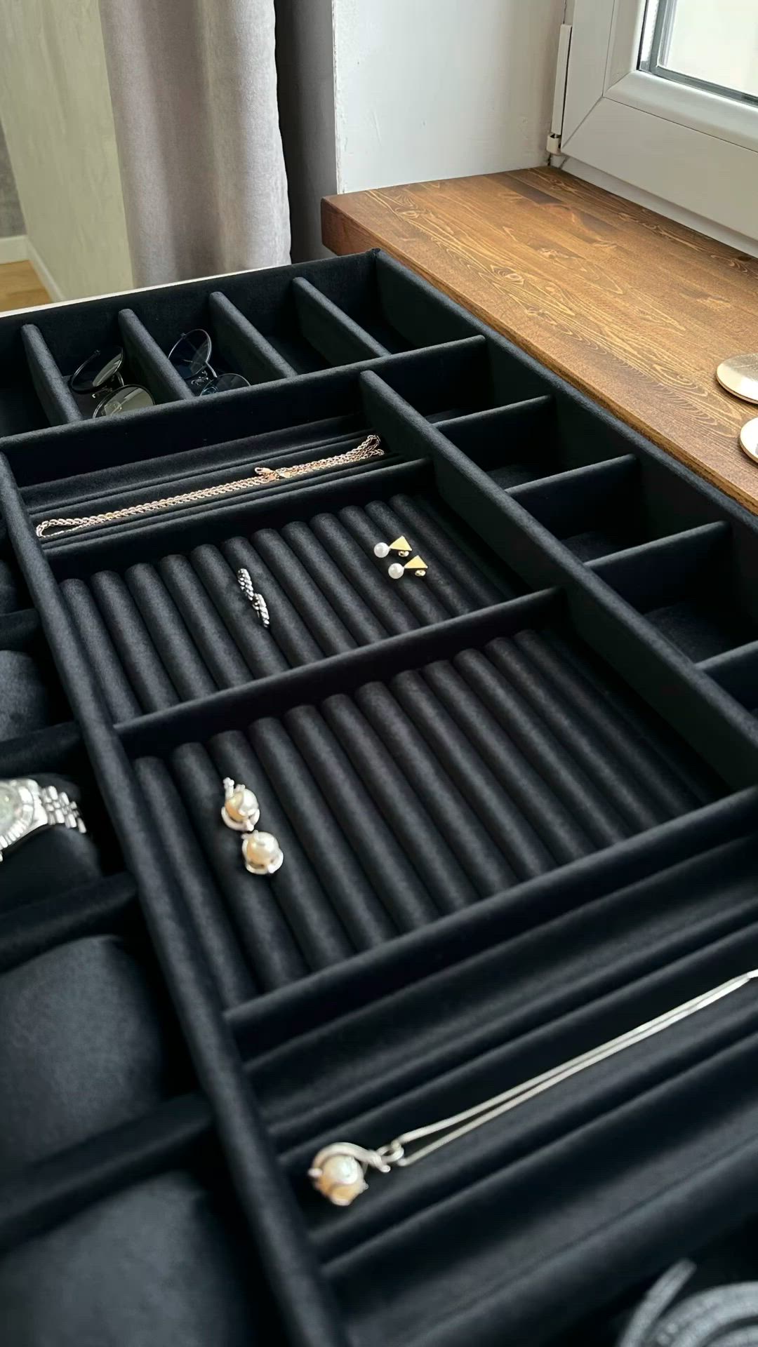 This may contain: an open drawer with several pairs of jewelry in it