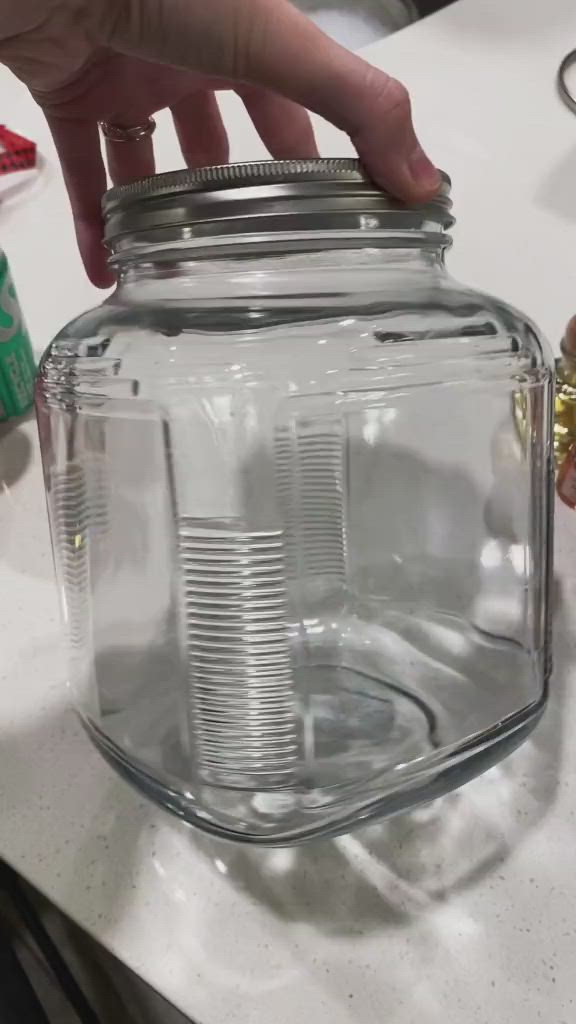 This may contain: a mini bar in a jar with a sign attached to it that says,'mini bar in a jar '