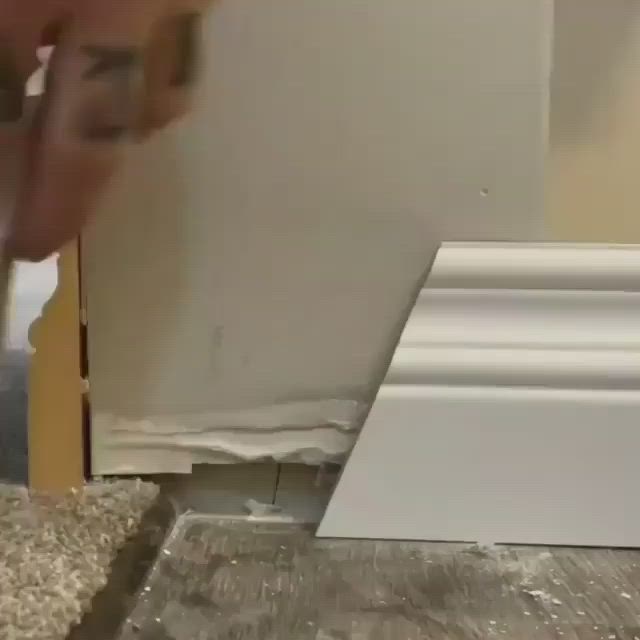 This may contain: a person is working on a piece of wood with a screwdriver next to it