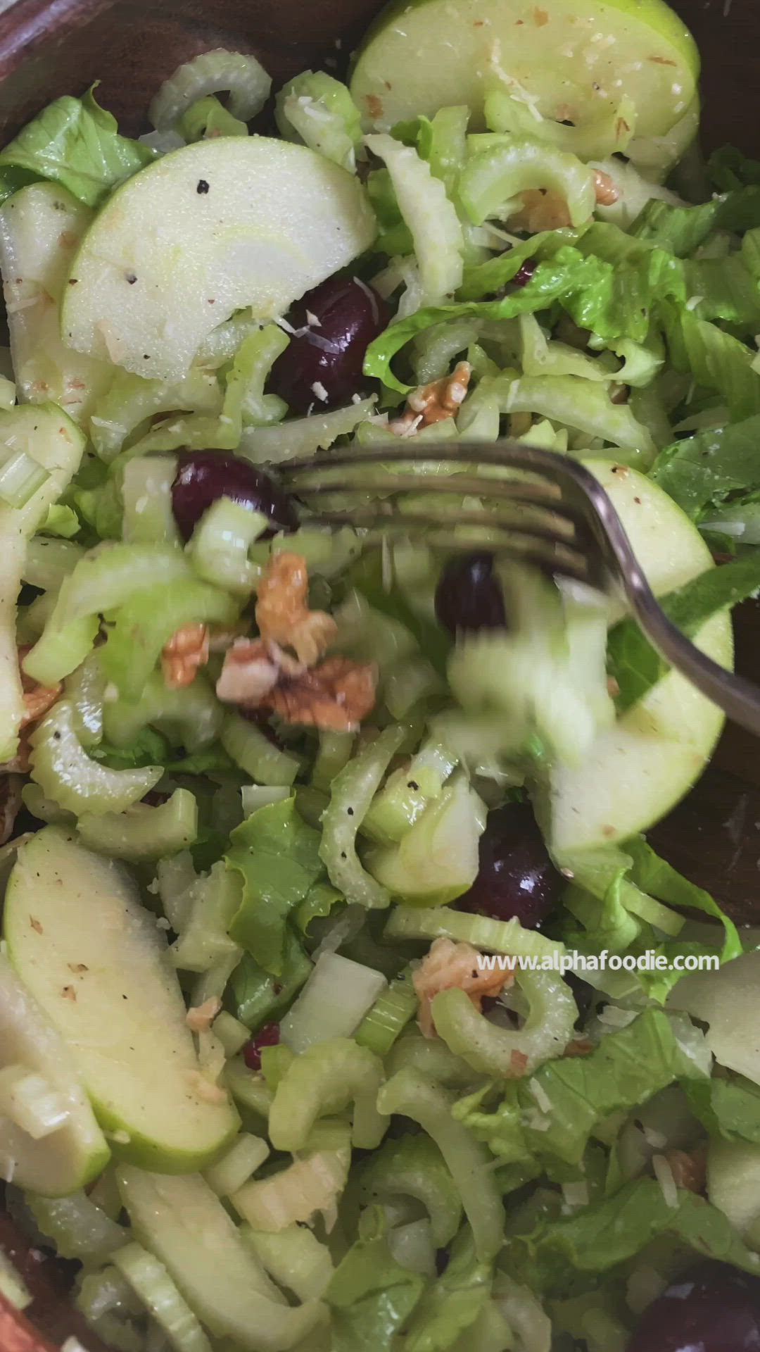 This may contain: a close up of a salad in a bowl with a fork