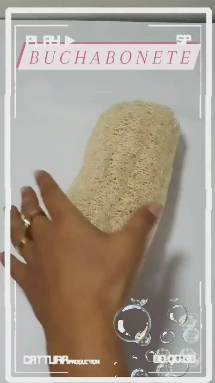 This may contain: a person's hand holding onto a sponge