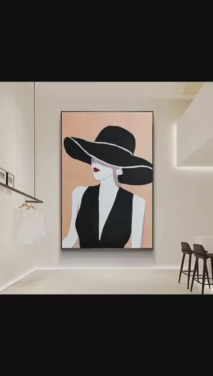 This may contain: a person is painting a woman's black hat on a pink and white canvas