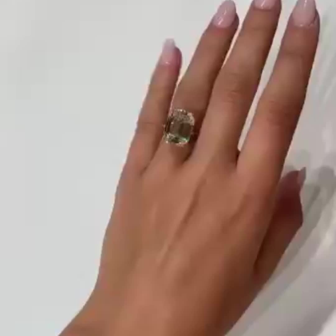 This may contain: a woman's hand with a ring on it