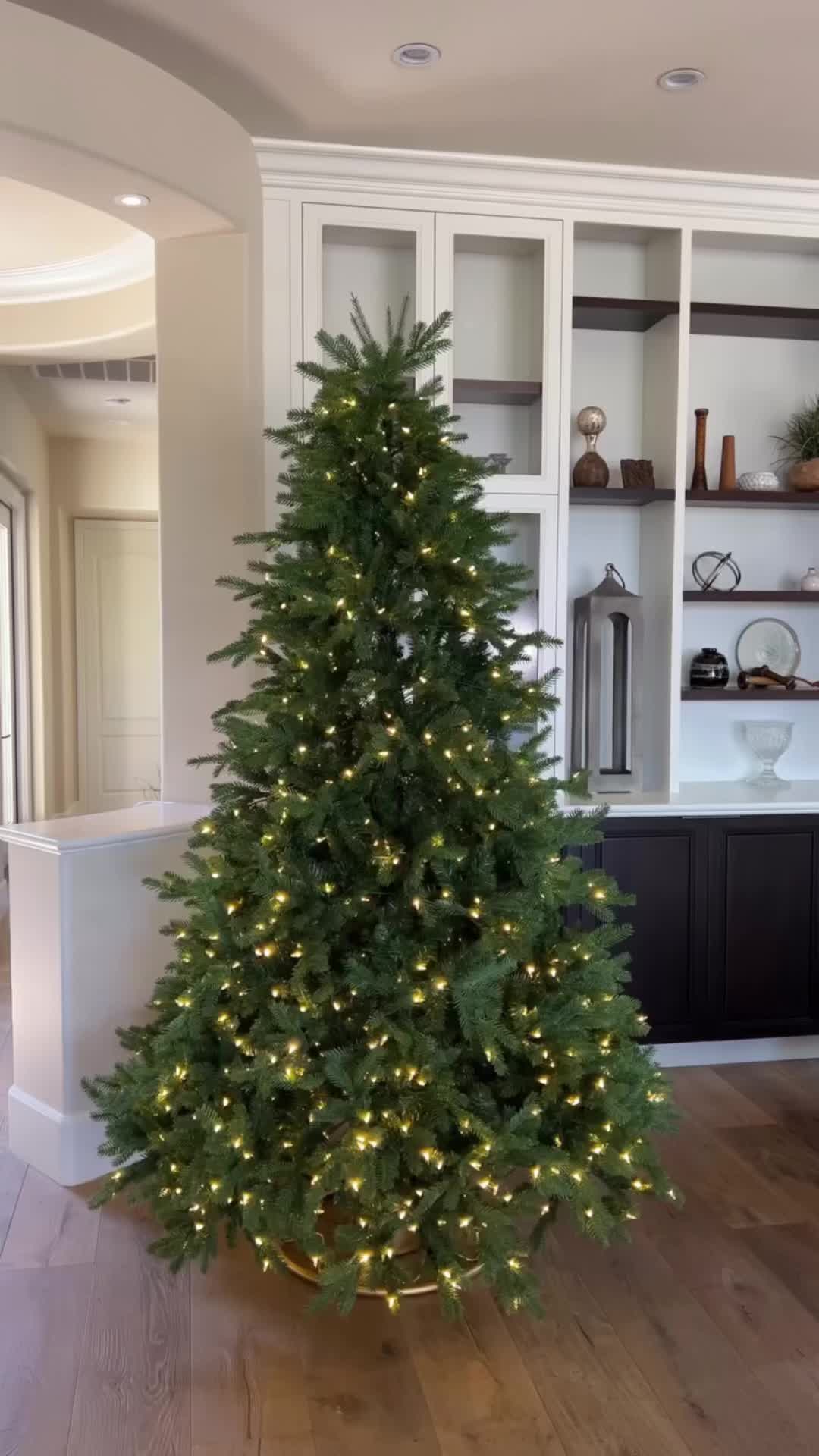 This may contain: a christmas tree decorated with red, white and blue bows