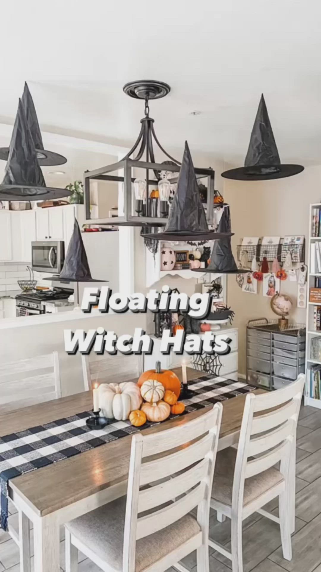 This may contain: an image of a dining room with witch hats on the table and pumpkins in the middle