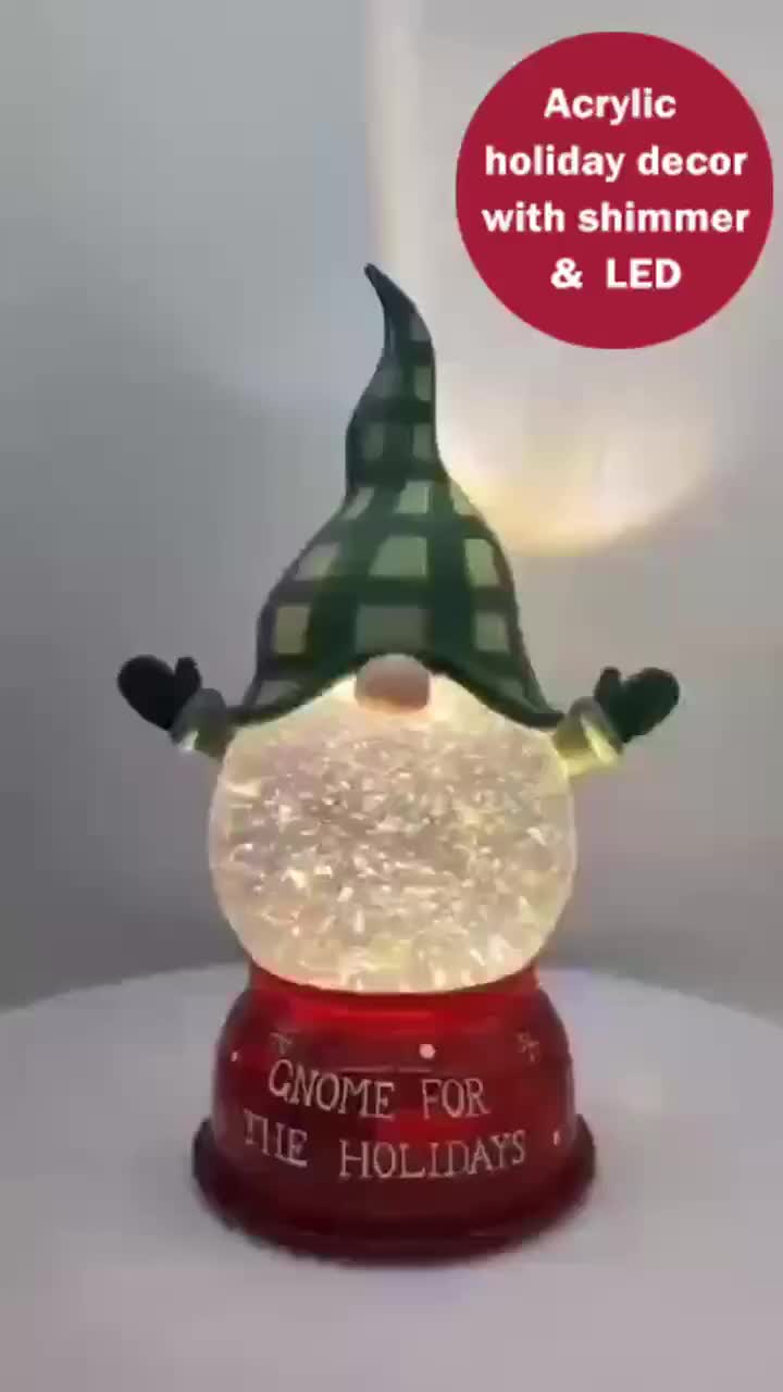 This may contain: a lighted snow globe with an acrylic holiday decoration on top and the words come for the holidays above it