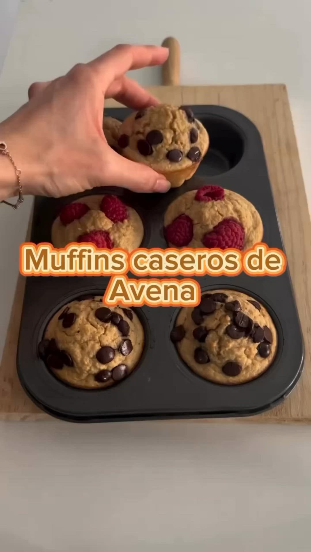 This may contain: muffins caseros de avena are being held up by a hand