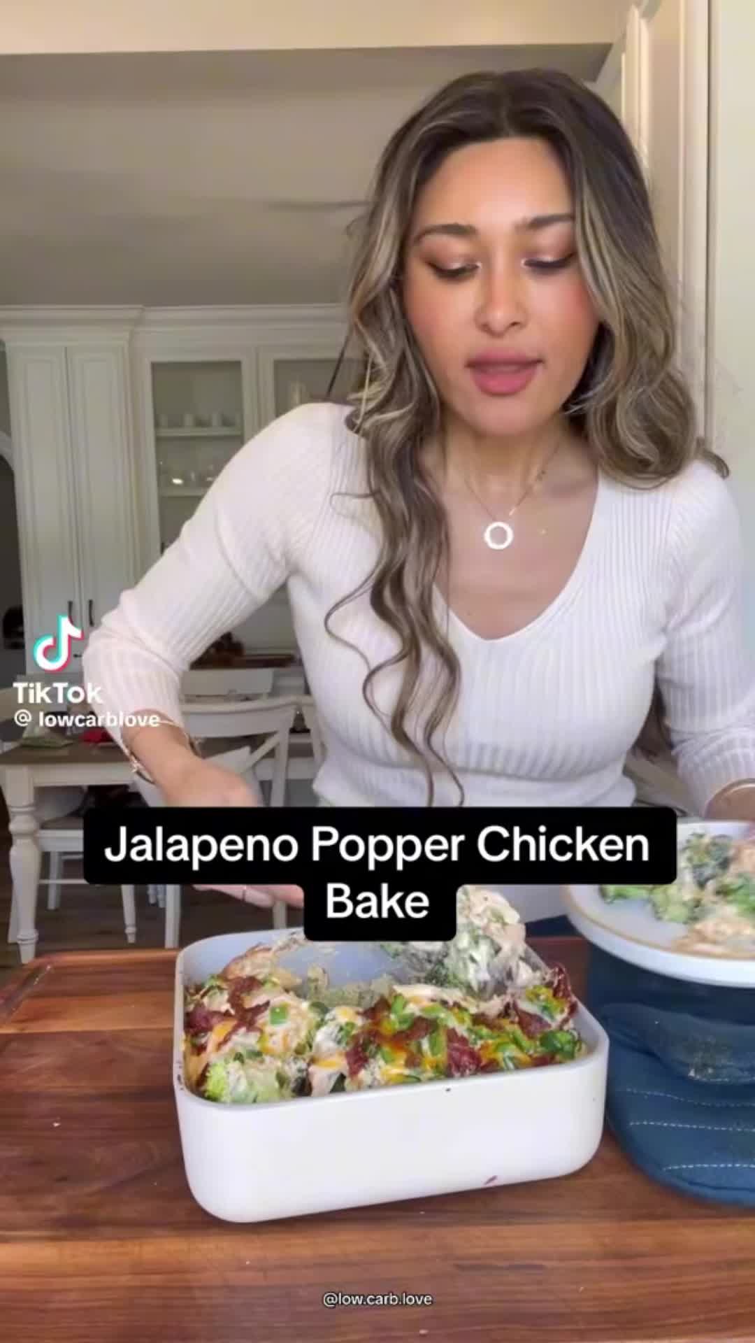 This may contain: a woman is making food on the kitchen counter with words above it that read jalapeno popper chicken bake