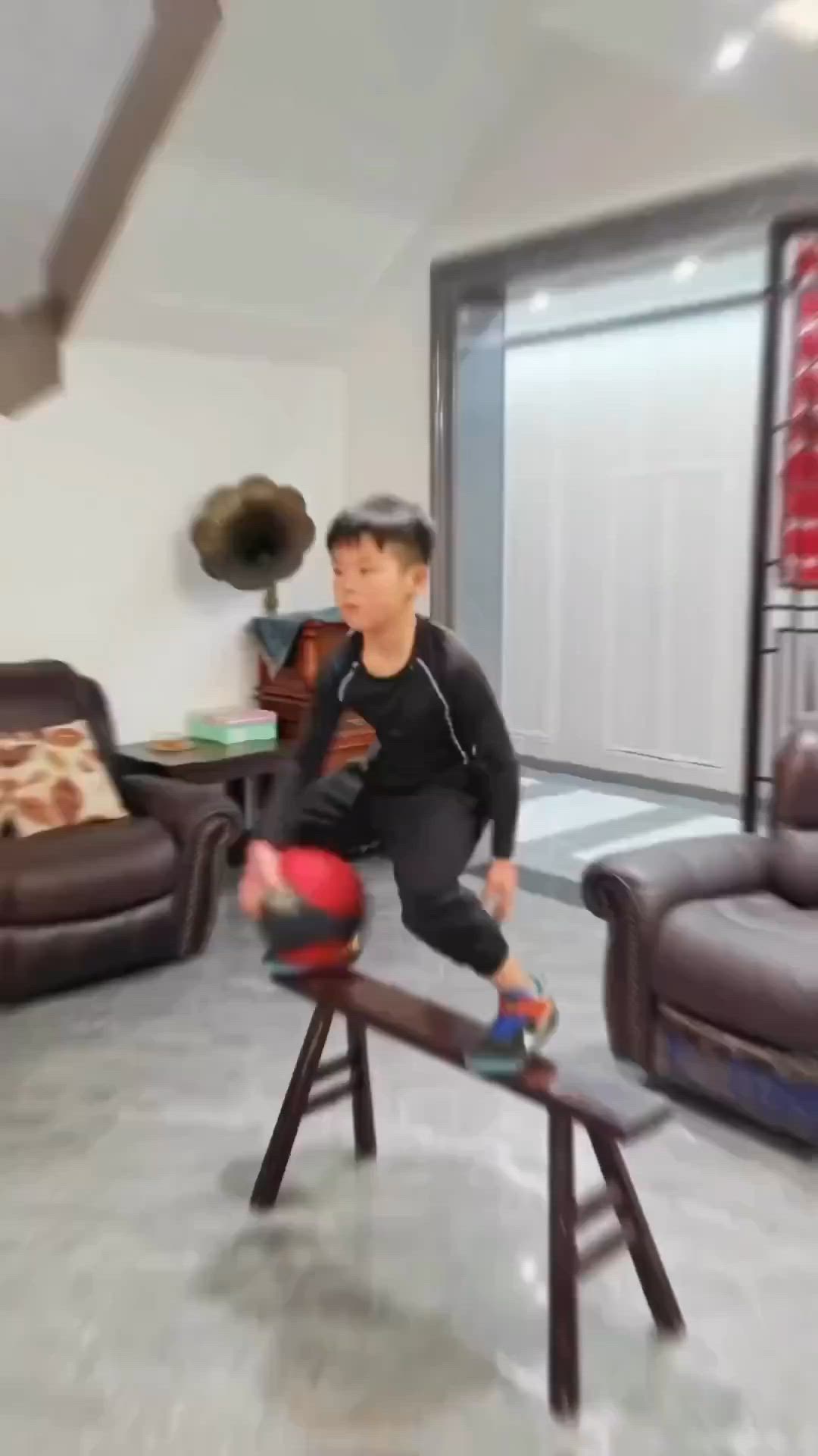 This may contain: a man is balancing on a stool in the living room