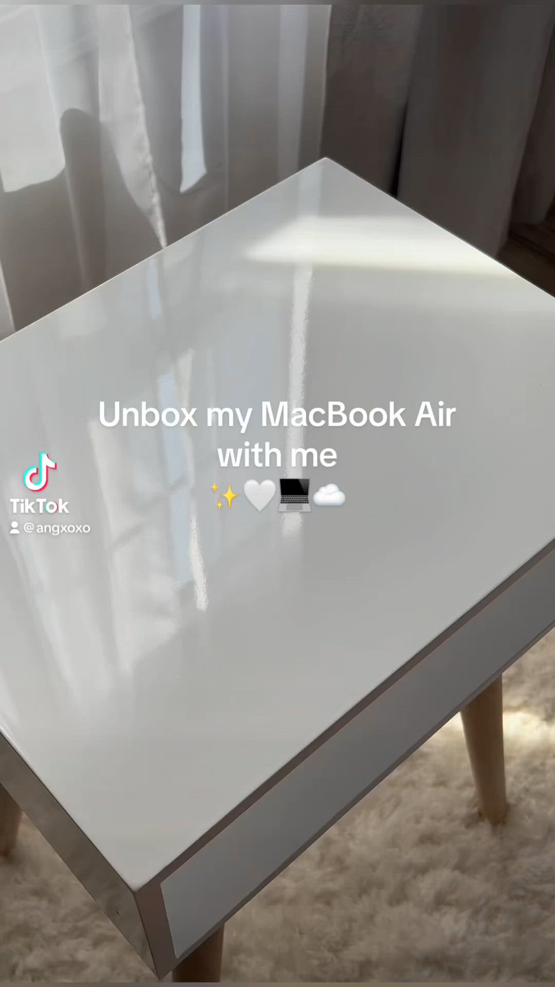 This may contain: a white table with the words unbox my macbook air written on it in front