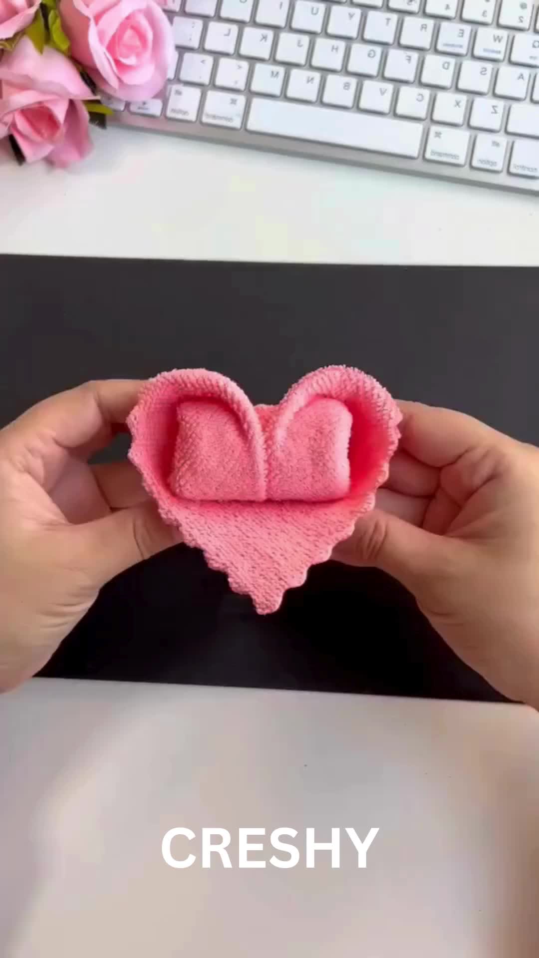 This may contain: two heart shaped hair clips sitting on top of a desk next to a computer keyboard