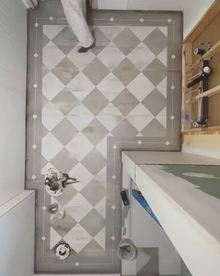 This may contain: an overhead view of a bathroom with tiled walls and flooring in grey and white