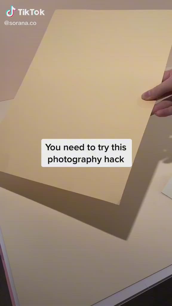 This may contain: a person holding a piece of paper with the caption you need to try this photography hack