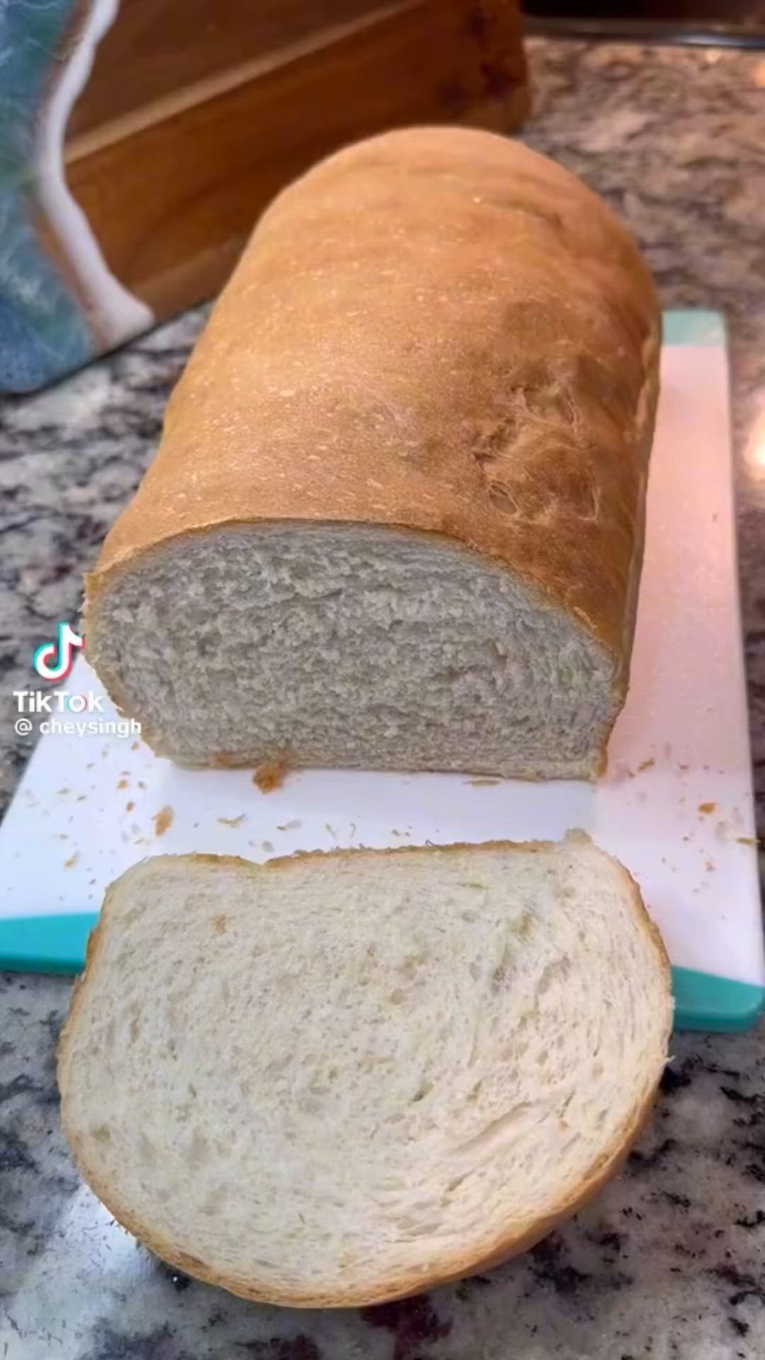 This may contain: a loaf of bread sitting on top of a cutting board