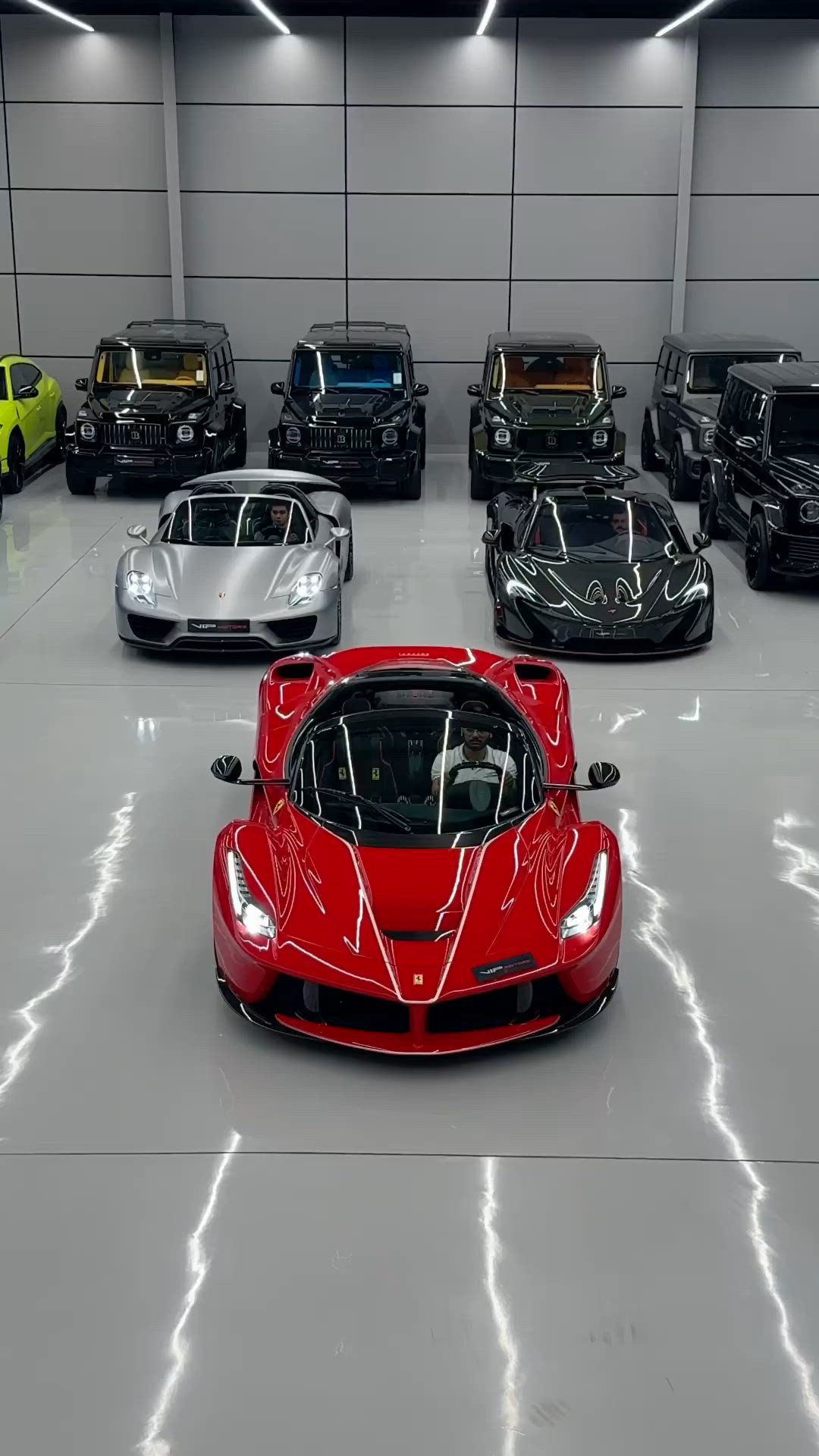 This may contain: a bunch of different colored sports cars in a garage