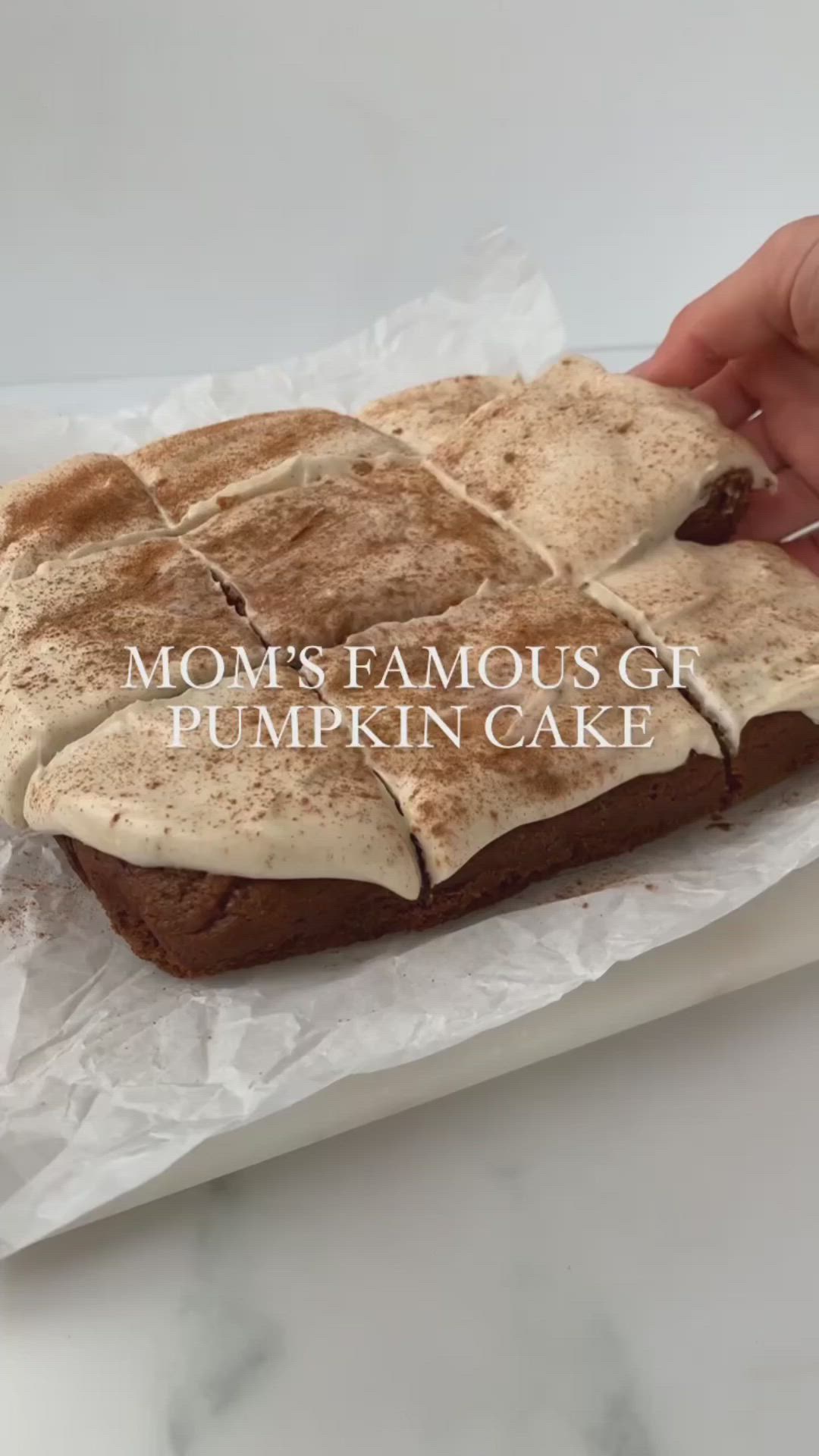 This may contain: a person is holding a piece of cake with frosting on it and the words mom's famous gf pumpkin cake