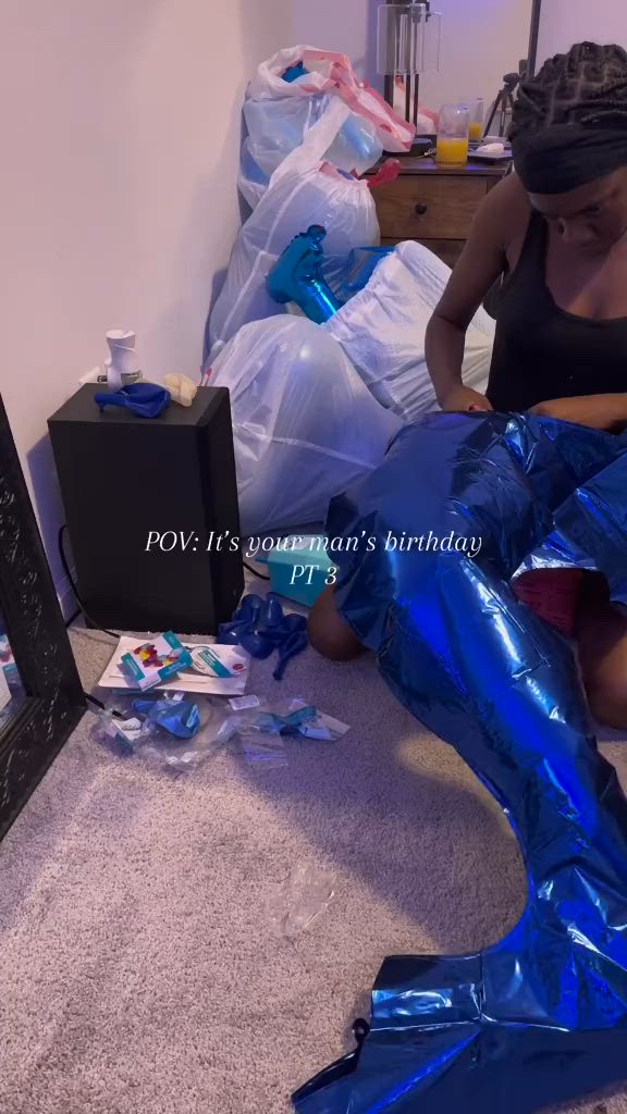 This may contain: a woman sitting on the floor in shiny blue boots