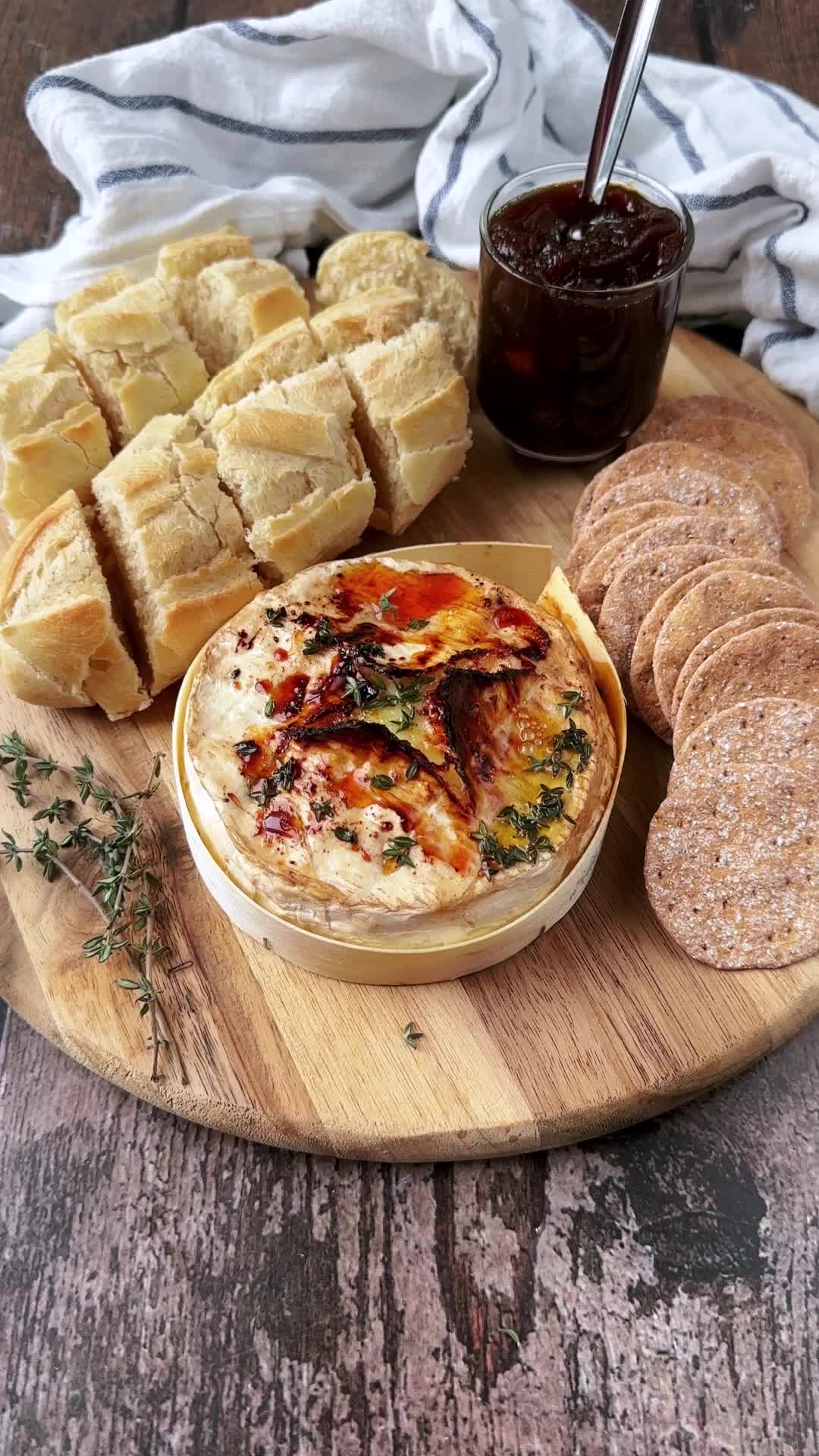 This contains: A video showing some bread being dipped into melted camembert.