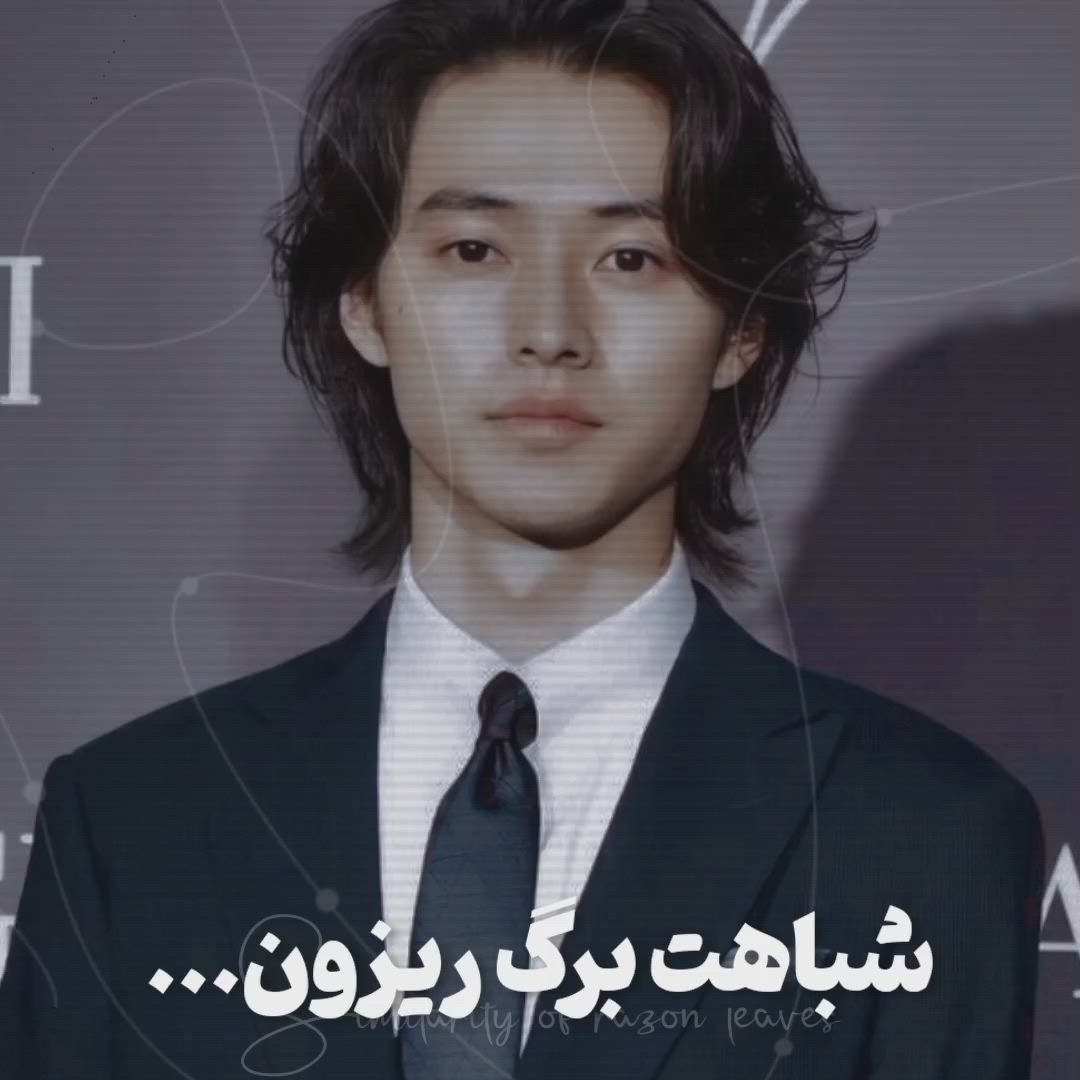 This may contain: a young man in a suit and tie with an arabic quote on the screen behind him