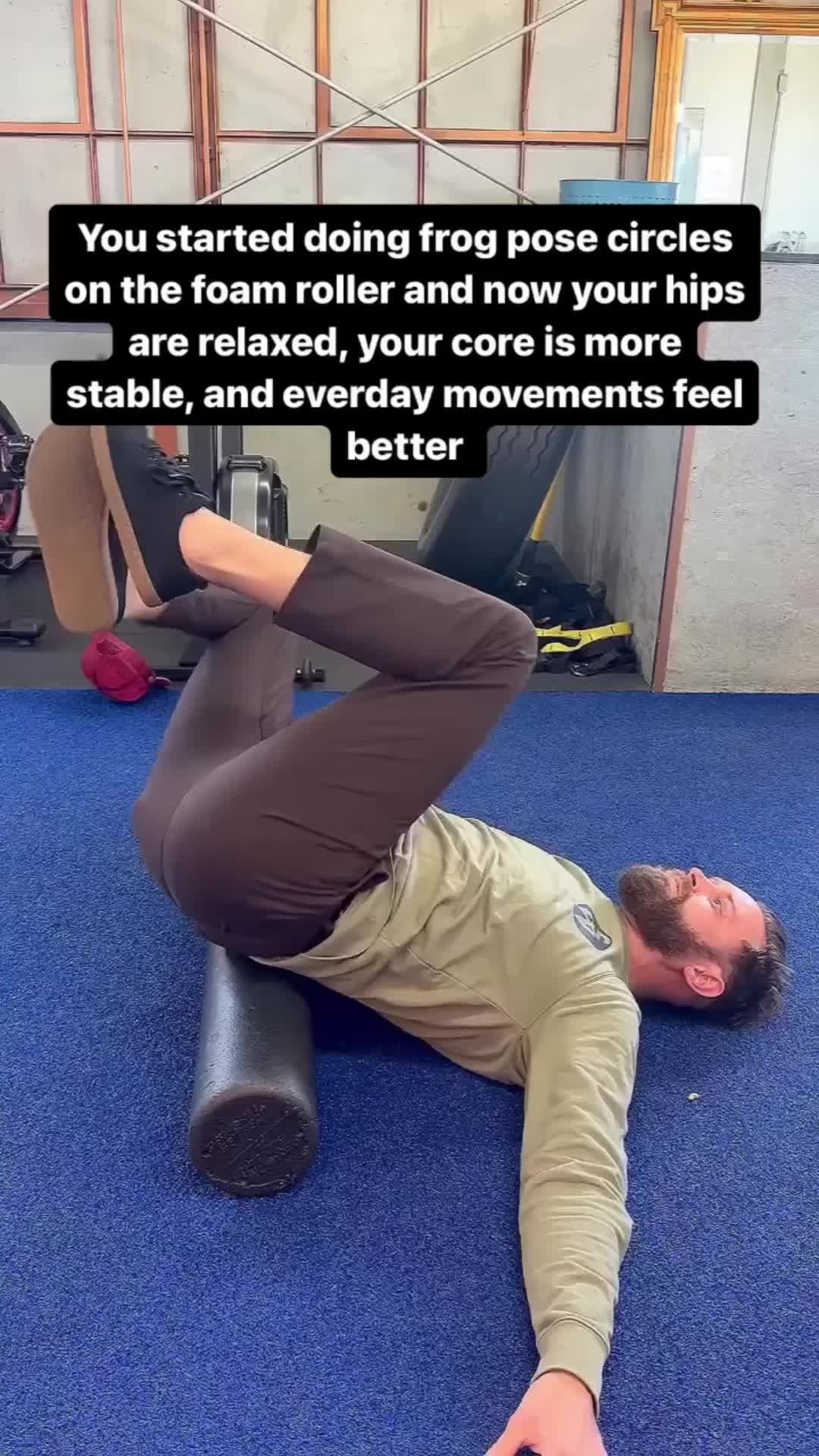 This may contain: a man laying on the ground in front of a gym machine with his arms and legs stretched out