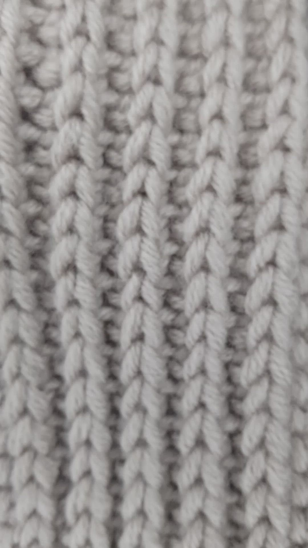 This may contain: the texture of a knitted blanket is shown in grey and white colors, as seen from above