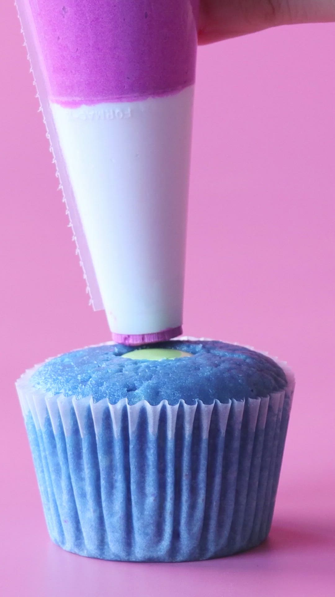 This may contain: cupcakes alien do toy story on pink background with purple and white icing