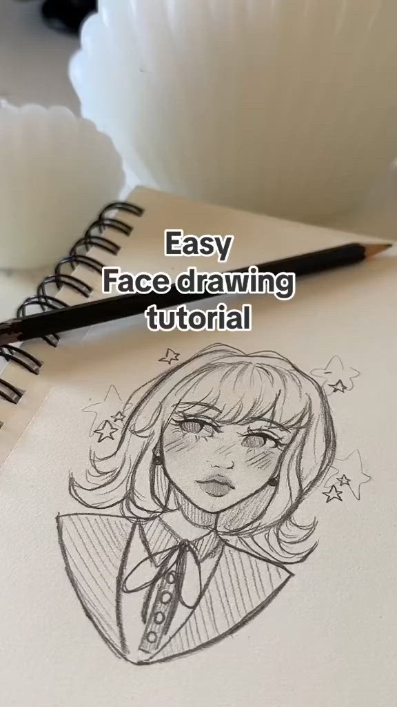 This may contain: an easy face drawing for beginners with a pencil and paper on the table next to it