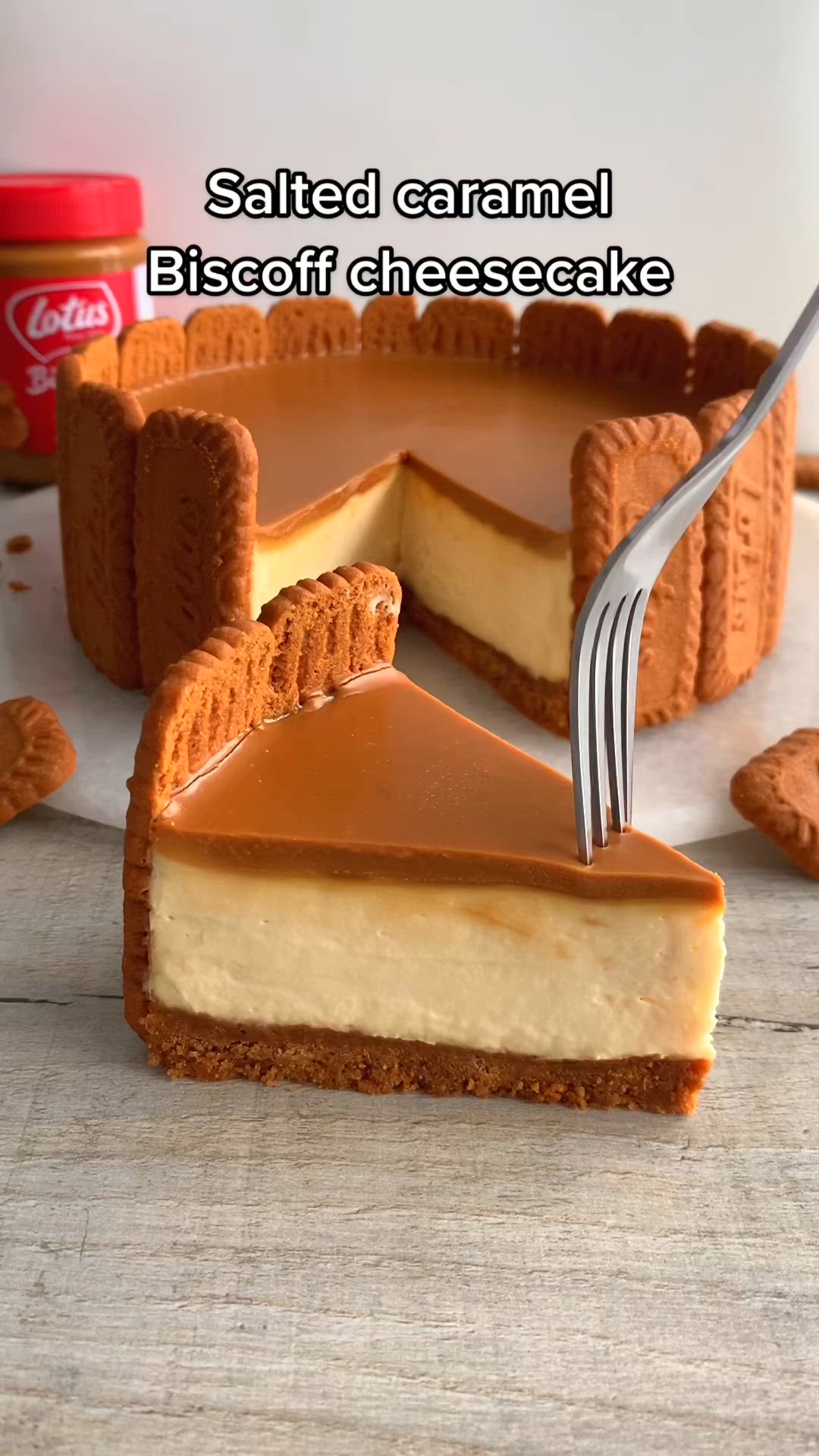 This contains: "Savor the heavenly harmony with our Salted Caramel Biscoff Cheesecake – a symphony of Biscoff cookies, creamy cheesecake, and indulgent salted caramel. Pin this recipe for an unforgettable dessert! 🍰�🍪"