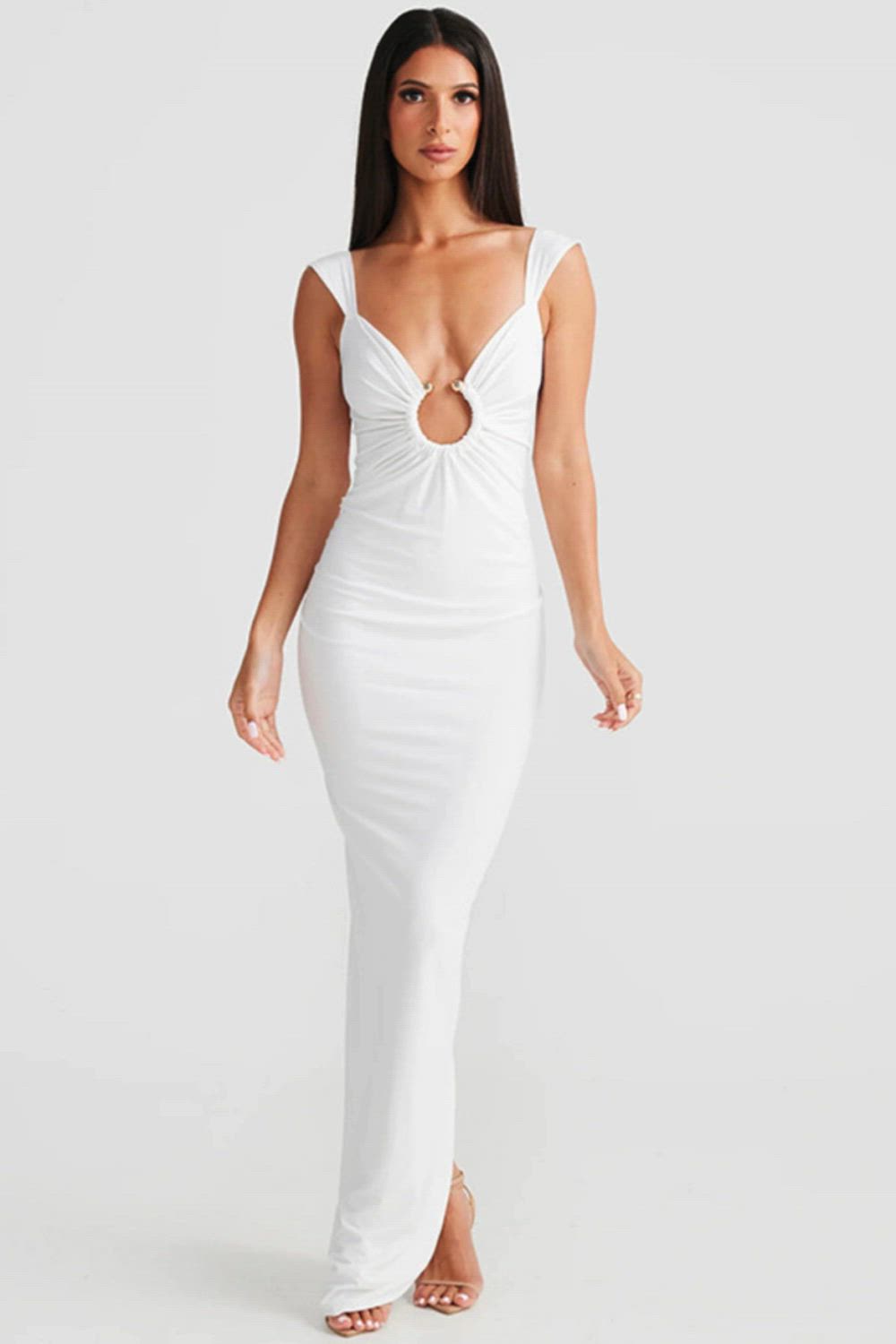 This contains: Our Low Cut Sleeveless Sexy Maxi Dress is perfect for any fashion-forward woman. With its backless, bodycon design and back split, this dress will highlight your figure and make you stand out. The low cut neckline adds a touch of sexiness, making it the perfect evening dress. Style and elegance all in one.