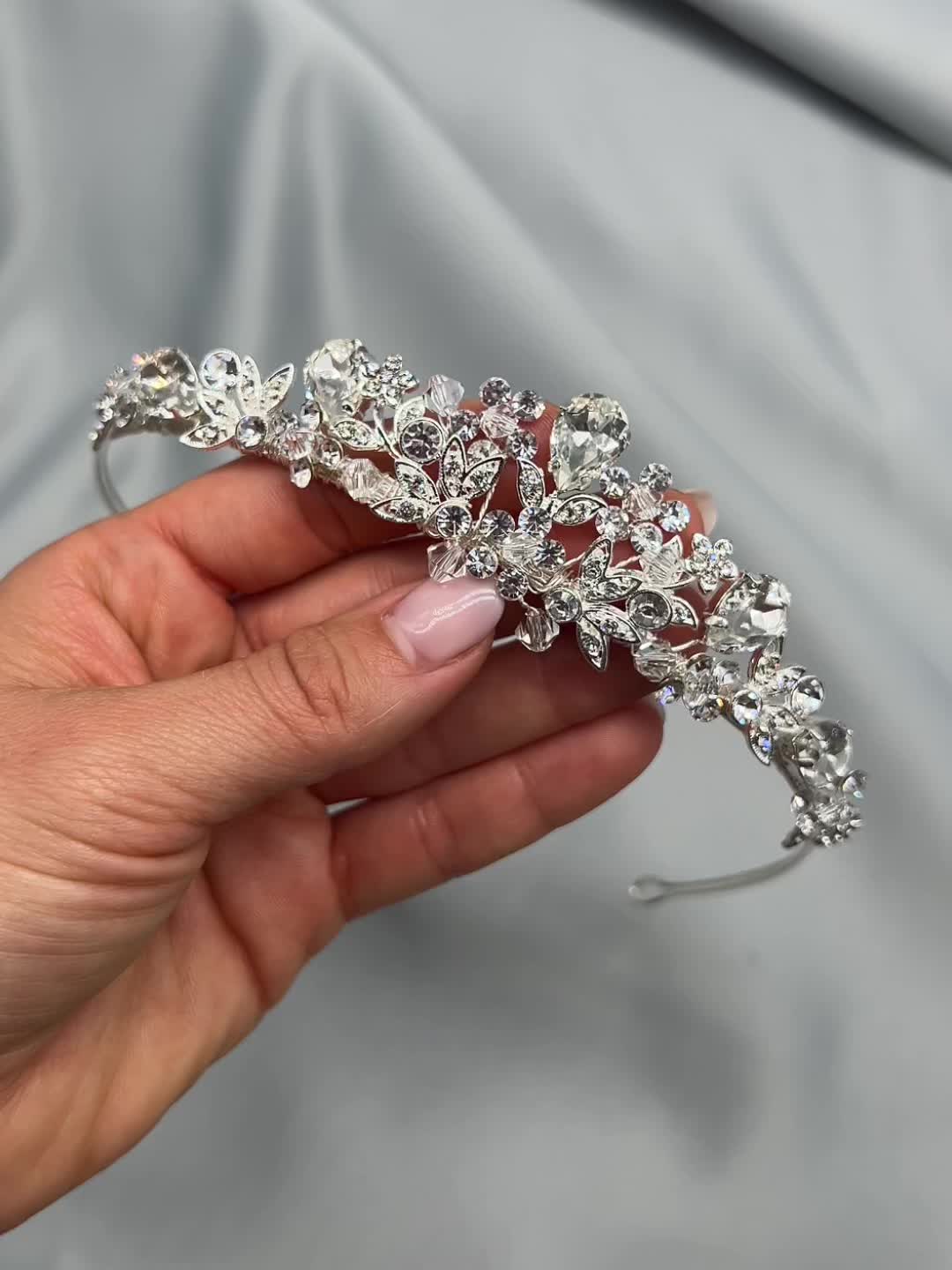 Petite & perfectly floral, bridal tiara Nicolette will sparkle from all angles as you walk down the aisle. Lightweight & easy to style. Designed with jeweled leaves, crystal beads & gemstones. 1.25" at the center peak. Pin loops at each end to secure in your hair with bobby pins, if needed. The sturdy yet flexible nature of the tiara allows you to comfortably shape to your hairstyle. Style #3008