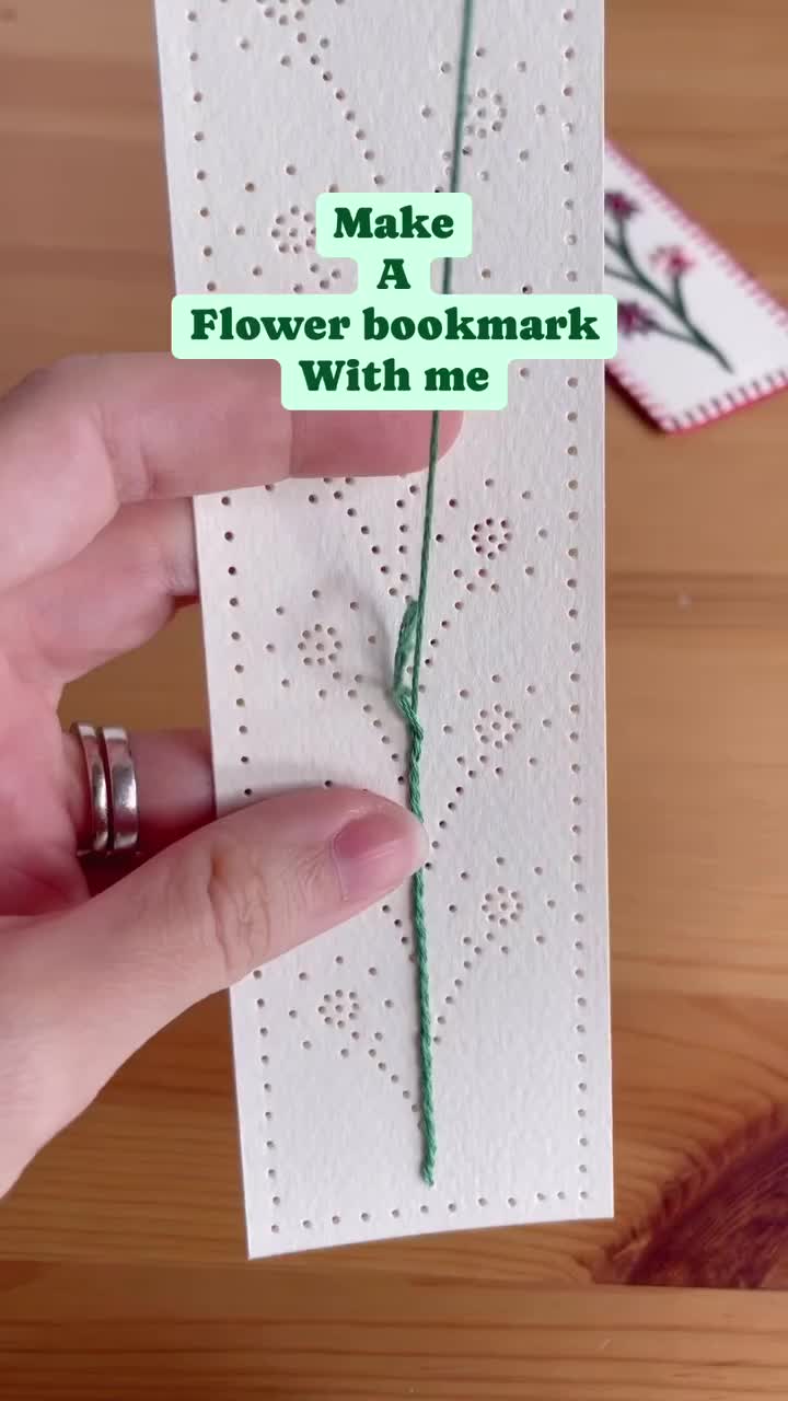 This may contain: an open book with embroidered flowers on it